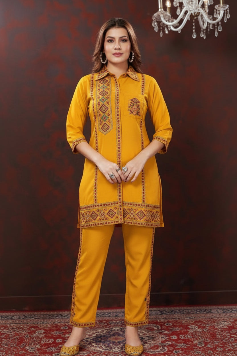 Woman wearing a yellow outfit sitting on a patterned rug with a dark background.