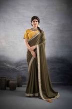 A woman modeling a traditional Indian saree in a studio setting, shown in two side-by-side views. The saree is olive green with a gold and silver border, paired with a yellow embroidered blouse.
