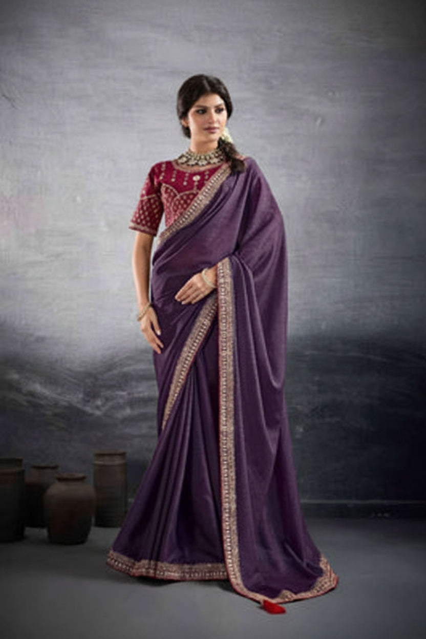A woman modeling a purple saree with a heavily embroidered magenta-pink blouse and gold border details, shown in a split studio portrait against a dark gray background. The brand name 'suma MEHAR' is visible at the top.