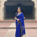 Woman in a blue saree with a blurred background