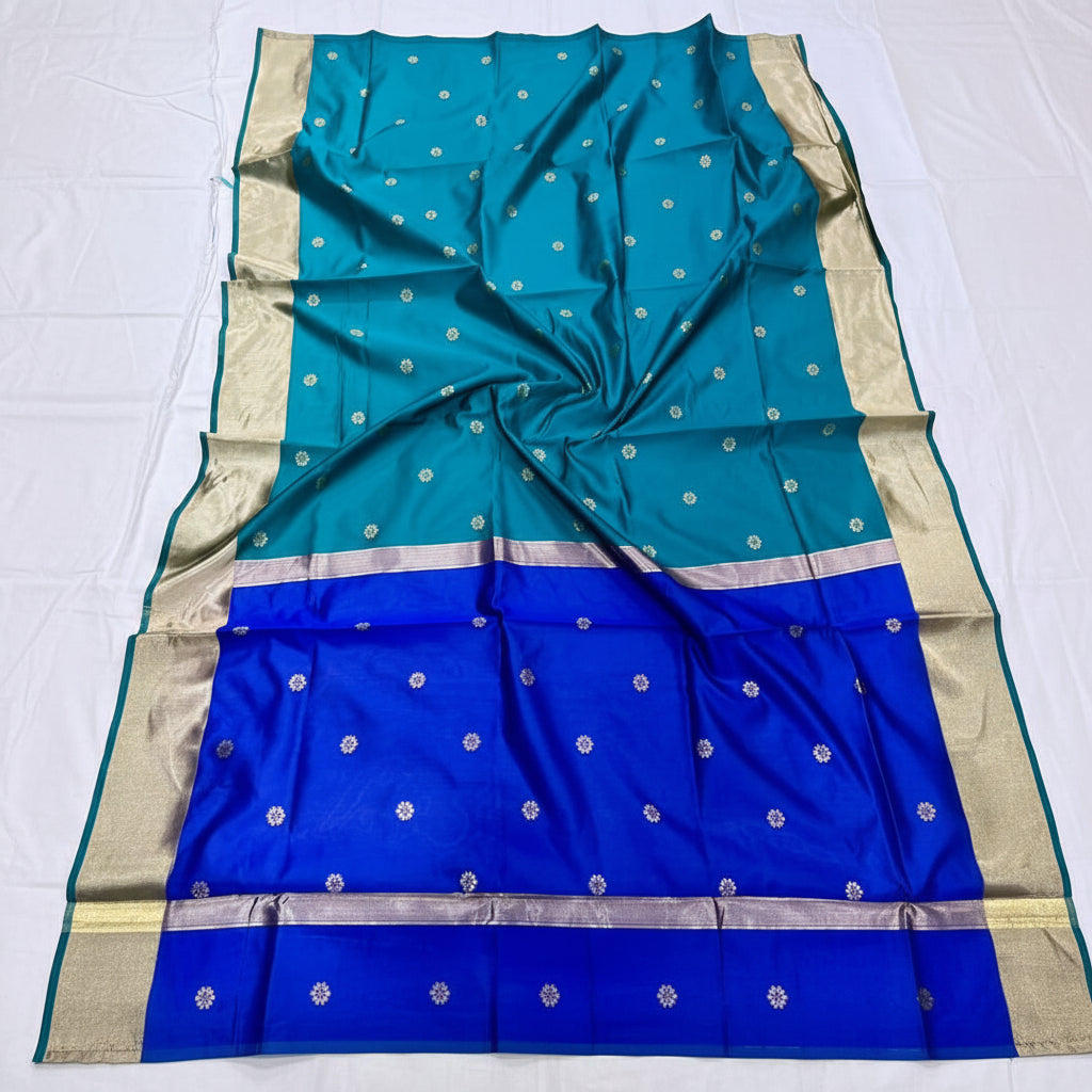 Blue and green saree with silver patterns on a white background