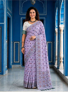 Woman wearing a purple saree with a blue background