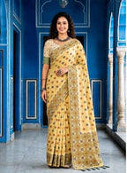 Woman wearing a yellow saree with a blue architectural background