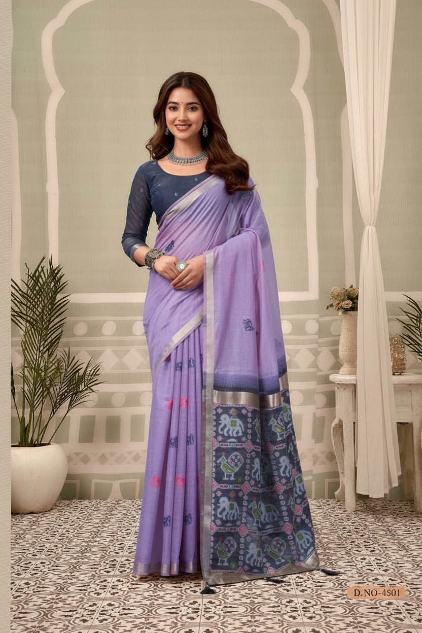 Woman wearing a purple saree with a patterned border indoors, with 'Gobuni' branding.