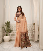 Woman in a peach saree with a mirror reflection in an elegant interior setting