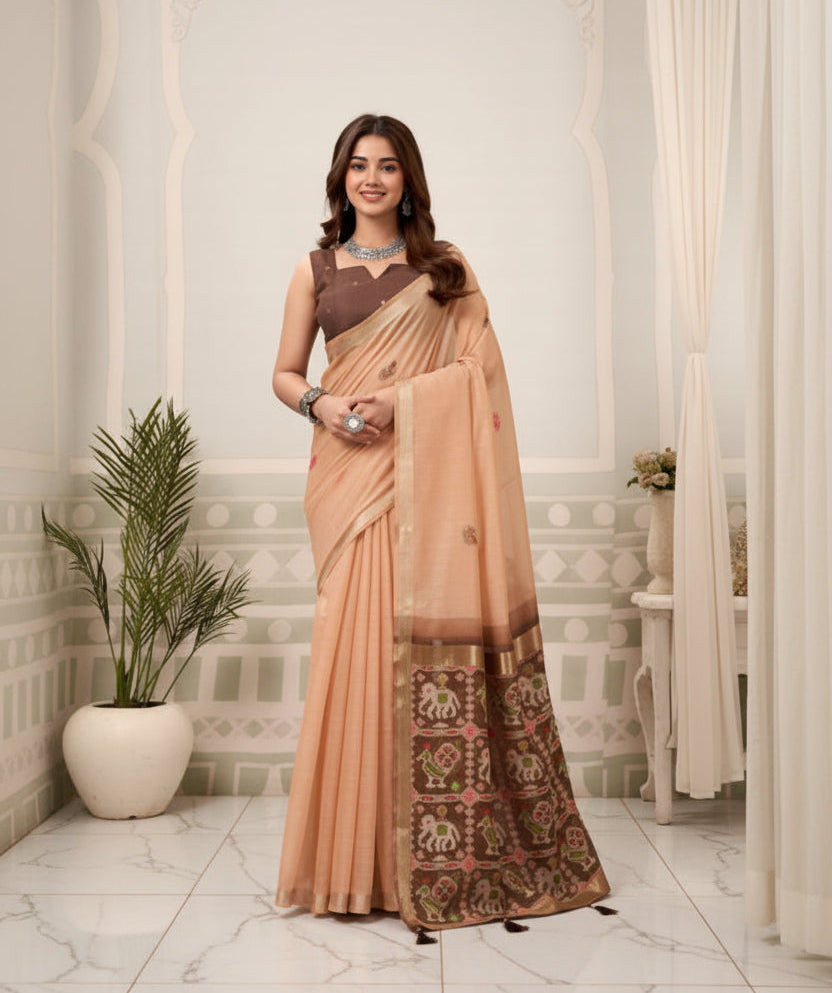Woman in a peach saree with a mirror reflection in an elegant interior setting