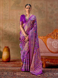 A woman modeling a purple and gold patterned saree in a styled indoor setting with ornate furniture and patterned wallpaper. The image is split into two vertical panels, with the Kreshna brand logo visible at the top right.