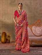 Woman in a traditional red saree with gold patterns, sitting on an ornate chair, with 'Kreshya' branding.