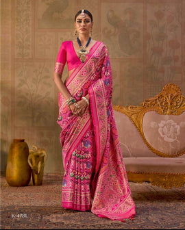A woman modeling a bright pink saree with intricate gold and multicolor floral patterns, shown in a split-screen presentation against a vintage-style beige background with a carved sofa and decorative vases.