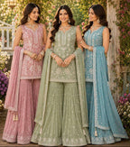 Three women in traditional outfits with 'GLORY' and 'Mrudang' branding in the background.