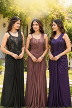 Three women wearing floor-length evening gowns in dark brown, dusty mauve, and deep purple, standing outdoors in front of a garden backdrop. The brand name 'NINA' is displayed at the top, along with the 'Mridang' logo.