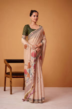 Woman wearing a saree with floral patterns against an orange background, featuring 'Rajpath' branding.
