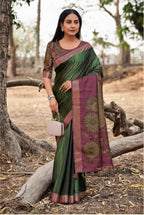 Woman wearing a green and purple saree with a Siddhanth logo in the background