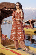 Woman in a traditional outfit on a boat with mountains in the background